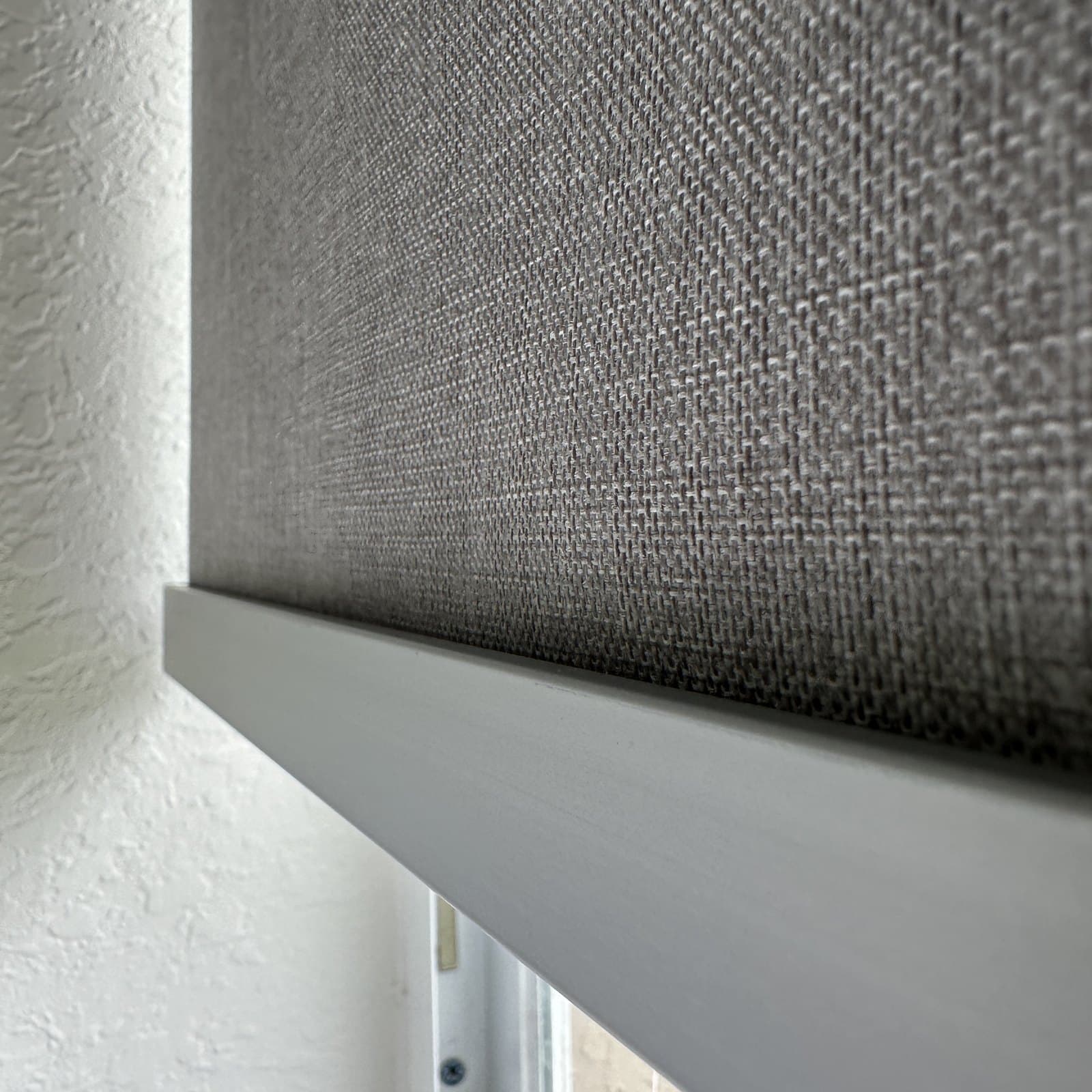 Close detail of a Weston roller shade fabric and bottom rail